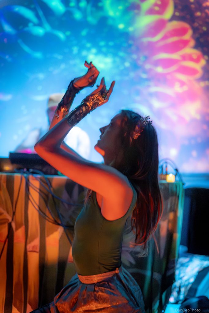 woman dancing while moving her hands in the air