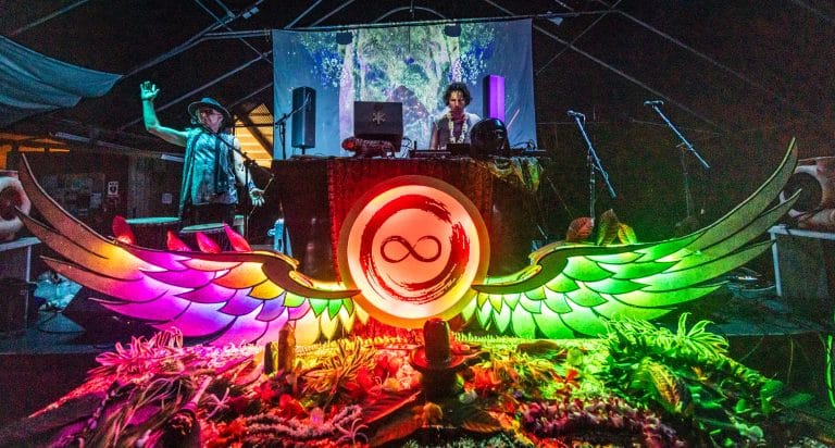 stage setup which resembles an altar with a glowing infinity sign and angel wings