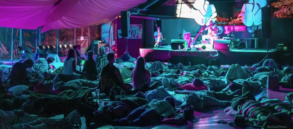 group of movement event attendees laying down on dance floor for an integration period