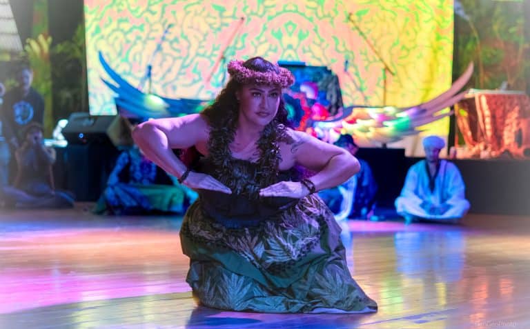 woman dressed in traditional ceremonial hwaiian clothing dancing