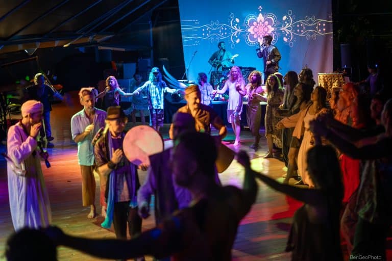 group of people dancing in a circle and holding hands at hoaloha movement event in hawaii